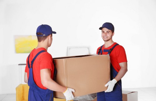 Professional house removalists in Brentcross loading moving boxes into a van