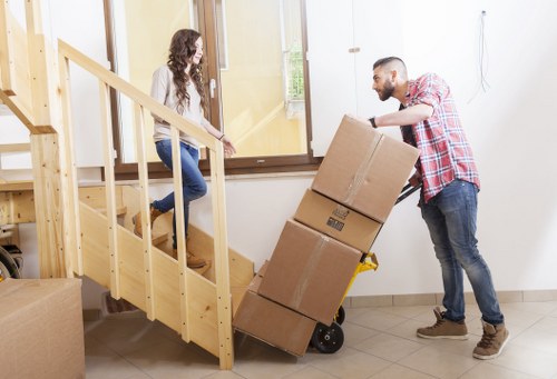 House removal team unloading boxes at a new home in Brentcross